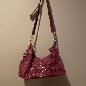Purple Leather BCBG MaxAzria Crossbody bag with gold tone hardware.